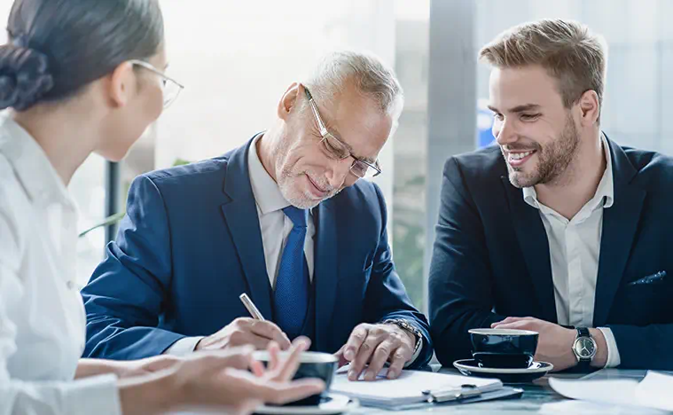 Three business people negotiating a contract.