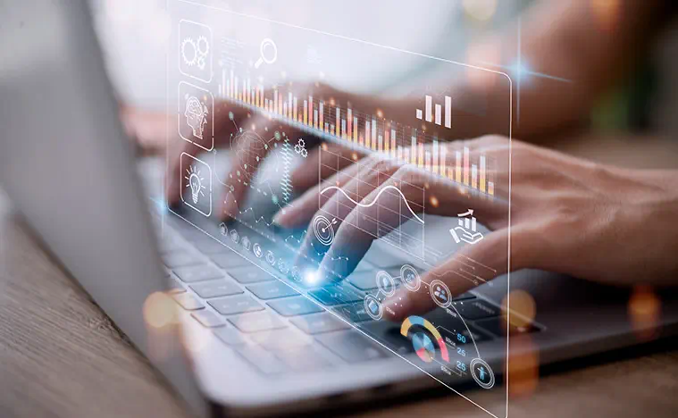 A business person working on their laptop with a bar chart super imposed on the image.