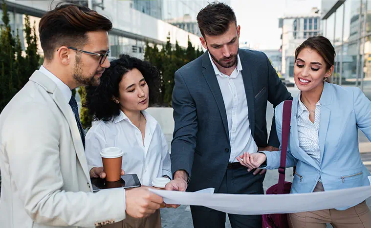 Renewals Relocations Expansions A group of business people outside of an office building.
