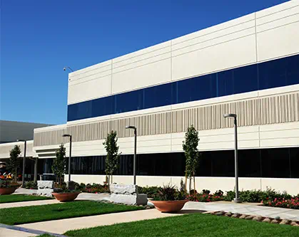 Exterior of a modern office building with green landscaping.