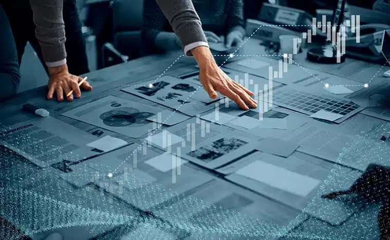 A business man looks over reports on his desk.
